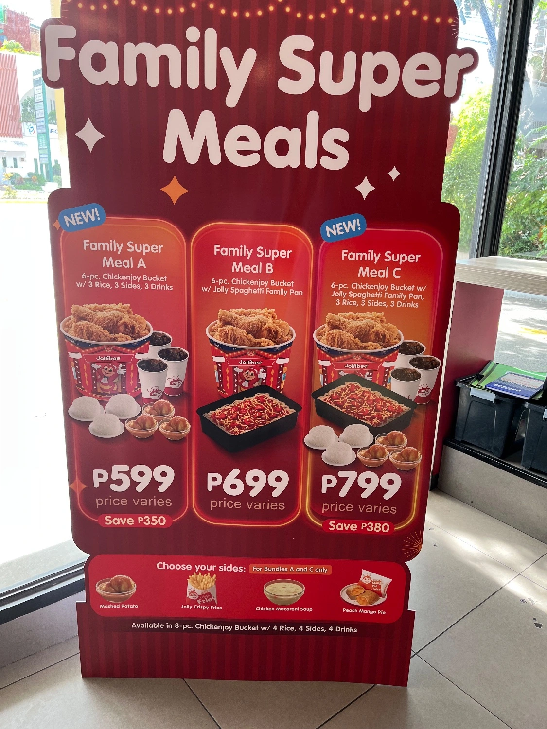 Poster advertising Jollibee Family Super Meals with three bundle options featuring fried chicken, rice, spaghetti, sides, and drinks, priced from ₱599 to ₱799.